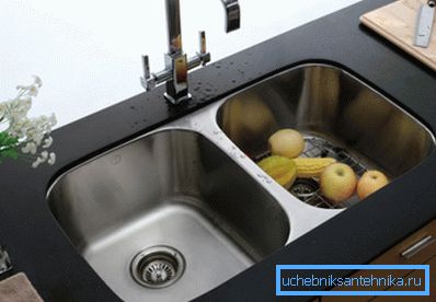 Il lavabo integrato da un acciaio inossidabile in un tavolo da una pietra artificiale. Il lavabo integrato da un acciaio inossidabile in un tavolo da una pietra artificiale.